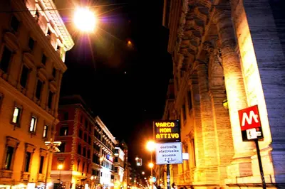 a city street at night with street lights and signs at Rome Center Attic Penthouse in Rome