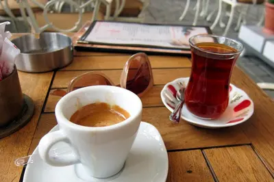 a cup of coffee sitting on a table with a cup of tea at Rome Center Attic Penthouse in Rome