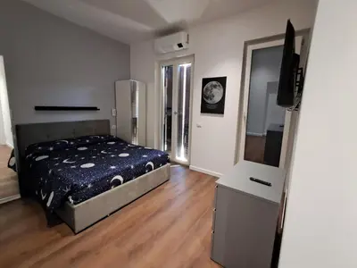 a bedroom with a bed and a flat screen tv at Pigneto New collection 1 in Rome