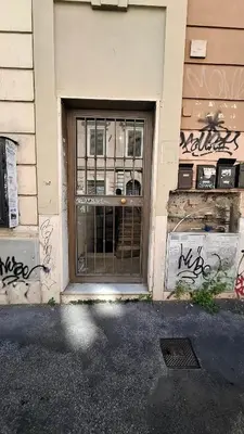 a door with graffiti on the side of a building at Pigneto New collection 1 in Rome