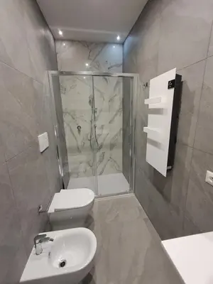 a bathroom with a shower and a toilet and a sink at Pigneto New collection 1 in Rome