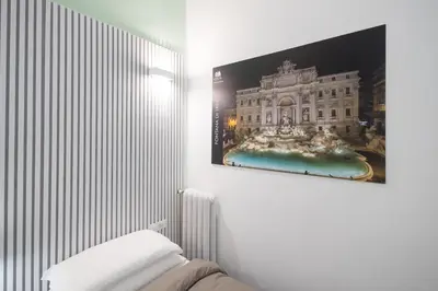 a bedroom with a picture of a building on the wall at Rome Capital Apartments in Rome