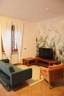 a living room with a couch and a television at casa di Stefano in Vaticano in Rome