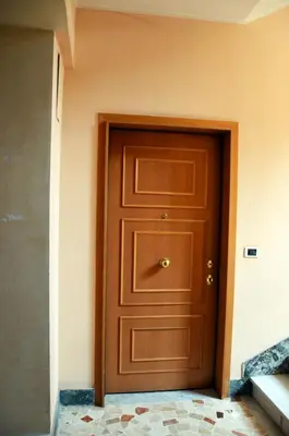 a wooden door in a room with a wall at casa di Stefano in Vaticano in Rome