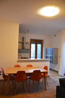 a dining room with a table and chairs in a kitchen at casa di Stefano in Vaticano in Rome