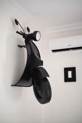 a motor scooter is hanging on a wall at Radio Suites in Rome