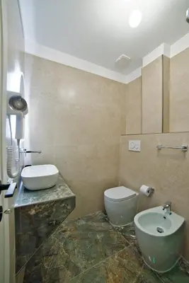 a bathroom with a white toilet and a sink at Radio Suites in Rome
