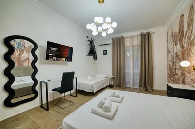 a bedroom with a bed and a mirror at Radio Suites in Rome