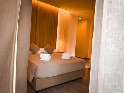a bedroom with a bed with two towels on it at Alma Guest House in Rome