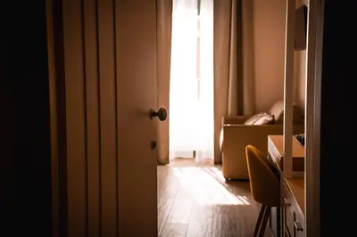 a door open to a room with a person in a box at Alma Guest House in Rome