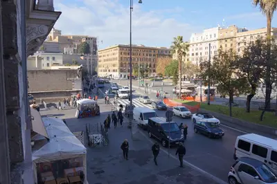a busy city street with cars and people on the street at Pope's Suites in Rome