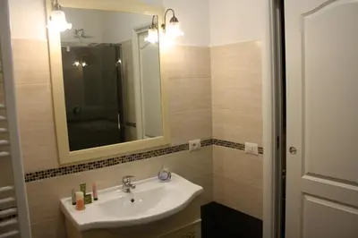 a bathroom with a sink and a mirror at Pope's Suites in Rome
