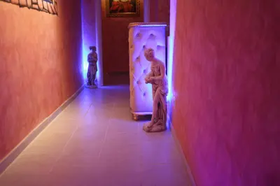 a couple of mannequins are standing in a hallway at Pope's Suites in Rome