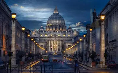 a large building with a domed building with cars at Pope's Suites in Rome
