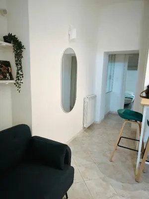 a living room with a couch and a chair at the italians house in Roma San Lorenzo in Rome