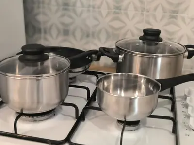 two pots sitting on top of a stove at the italians house in Roma San Lorenzo in Rome