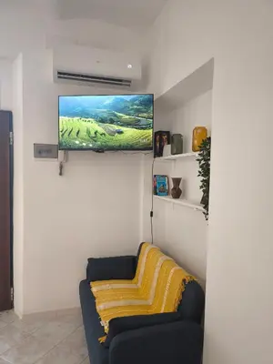 a living room with a couch and a flat screen tv at the italians house in Roma San Lorenzo in Rome