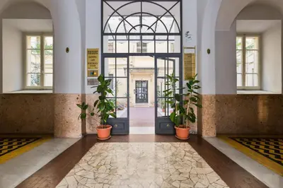 a lobby with potted plants in front of a door at Apartment near the Vatican in Rome