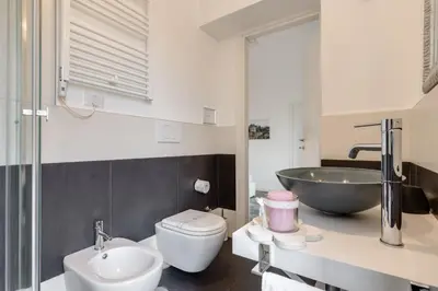 a bathroom with a sink and a toilet and a bath tub at Apartment near the Vatican in Rome