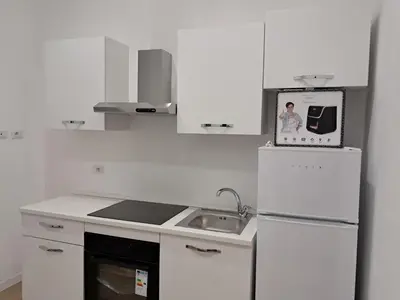 a white kitchen with a sink and a refrigerator at Pigneto New collection 2 Casilina in Rome