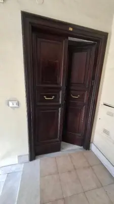 a wooden door in a room with a tile floor at Pigneto New collection 2 Casilina in Rome