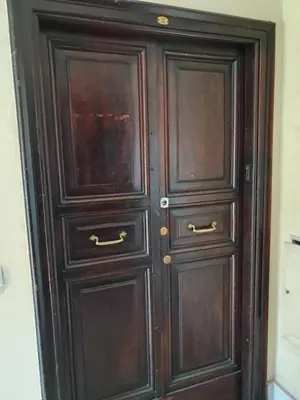 a pair of wooden doors in a room at Pigneto New collection 2 Casilina in Rome