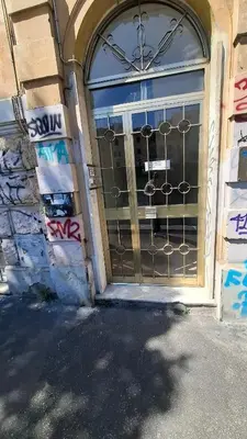 a door with a wrought iron gate on a building at Pigneto New collection 2 Casilina in Rome