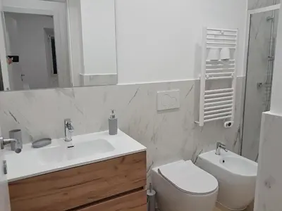 a bathroom with a sink and a toilet and a mirror at Pigneto New collection 2 Casilina in Rome