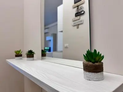 a white counter with three potted plants on it at Luxury Apartment Metro Cornelia in Rome
