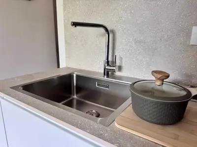 a kitchen sink with a pot on a cutting board at Luxury Apartment Metro Cornelia in Rome