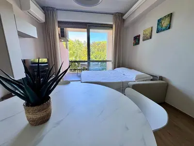 a room with a table and a bed and a window at Luxury Apartment Metro Cornelia in Rome
