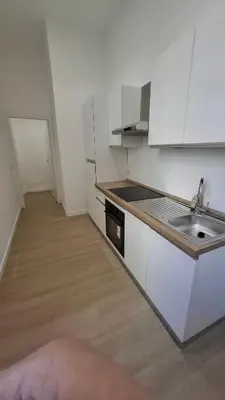 a kitchen with white cabinets and a sink at Pigneto New collection 3 Perugia in Rome