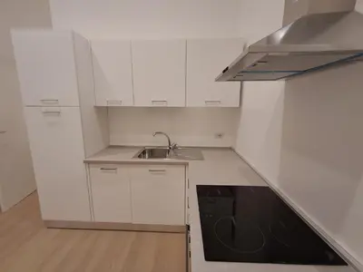 a small kitchen with white cabinets and a sink at Pigneto New collection 3 Perugia in Rome