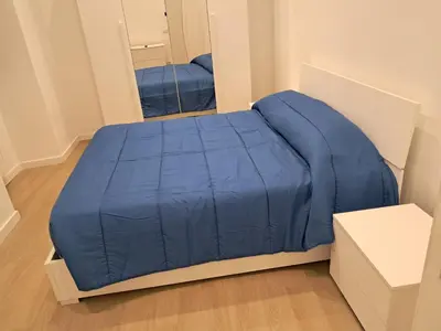 a blue bed in a room with a mirror at Pigneto New collection 3 Perugia in Rome