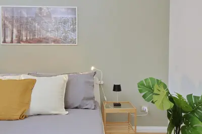 a bedroom with a bed with a plant next to it at Circo Massimo House by Luxury Getaways in Rome