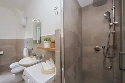 a bathroom with a shower and a toilet and a sink at Circo Massimo House by Luxury Getaways in Rome