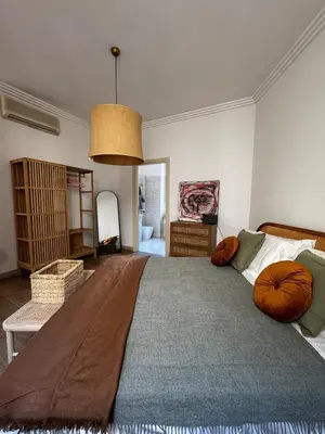 a bedroom with a large bed with a blue blanket on it at Roman Holiday Escape 2BDR Spanish steps and Trevi in Rome