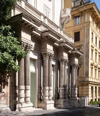 a building with columns on the side of it at Roman Holiday Escape 2BDR Spanish steps and Trevi in Rome