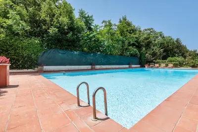 a large swimming pool with two metal rails in a yard at Aurelia vetus apartment Rome in Rome