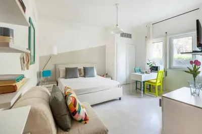a bedroom with a bed and a couch and a table at Aurelia vetus apartment Rome in Rome