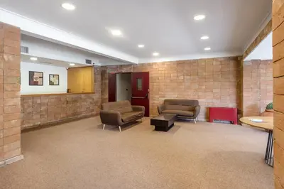 a waiting room with two chairs in a brick wall at Aurelia vetus apartment Rome in Rome
