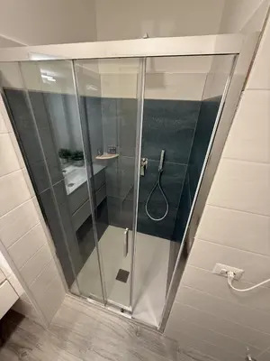 a shower with a glass door in a bathroom at Nest Love collazia Roma 1500 mt dal Colosseo in Rome
