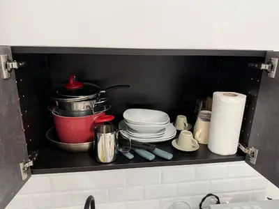 a kitchen shelf with dishes and a pot on it at Nest Love collazia Roma 1500 mt dal Colosseo in Rome