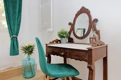 a kitchen and dining room with a table and chairs at Domus al Colosseo by Luxury Getaways in Rome