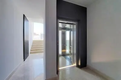an empty hallway with a glass door and stairs at Contemporary Apartment by Luxury Getaways in Rome