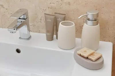a bathroom sink with a faucet and toiletries on it at Contemporary Apartment by Luxury Getaways in Rome