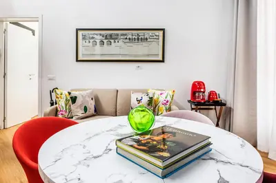 a bedroom with a white bed and a tv on the wall at Maison de Bretagne in Rome