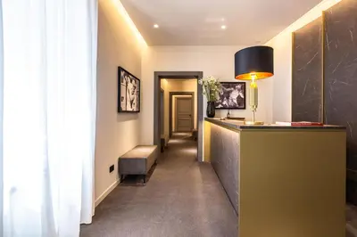 a hallway with a reception desk in a hotel room at Fontart Tritone in Rome