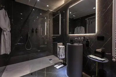 a black bathroom with a shower and a sink at Fontart Tritone in Rome