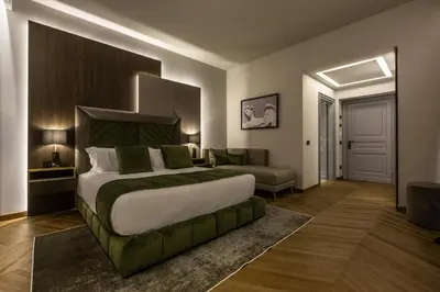 a bedroom with a large bed and a couch at Fontart Tritone in Rome